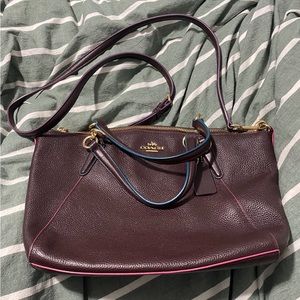 Medium sized cross body coach bag. Soft leather Burgundy with pink and blue trim